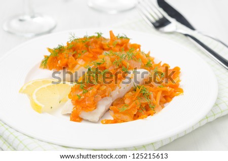 cod with pickled carrots and onions on a white plate horizontal