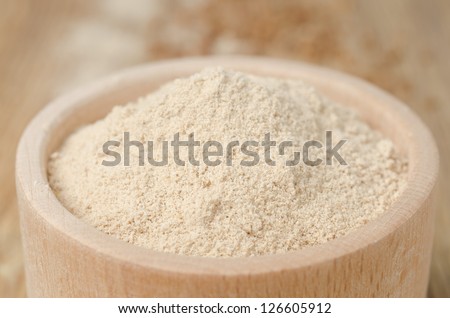 buckwheat flour in a wooden bowl horizontal