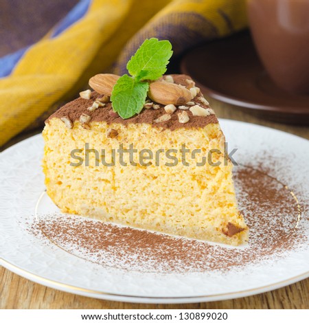 piece of pumpkin cheesecake decorated with cocoa and mint closeup