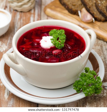 Ukrainian and russian national red borsch with sour cream closeup