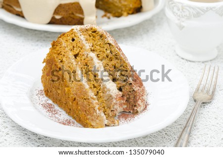 piece of carrots and pumpkin cake with coffee cream on the plate