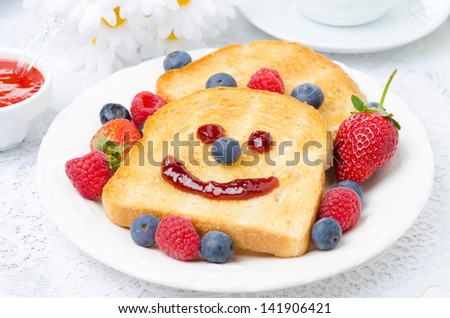Breakfast with a smiling toast, fresh berries, berry jam, horizontal