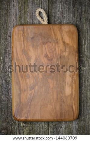 vintage cutting board with space for text on old wooden background, close-up
