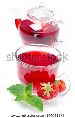 kettle and a cup of red tea with fresh strawberries and mint isolated on white background