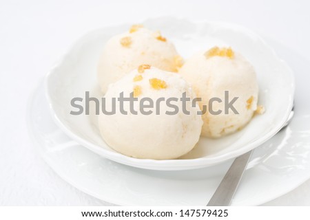 Ginger ice cream with melted milk in a bowl, horizontal