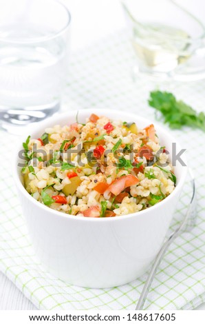 bowl of salad with bulgur, zucchini, tomatoes, chili peppers and parsley, vertical