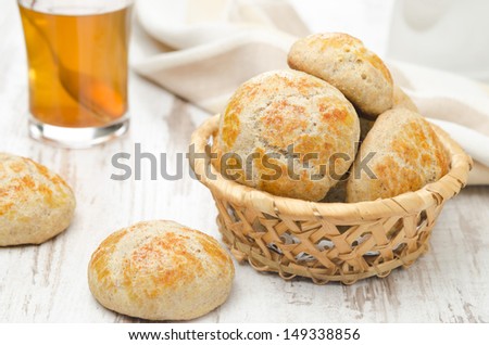 homemade cottage cheese bread rolls in a basket on a white table