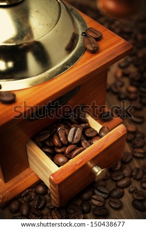 old coffee grinder and coffee beans, close-up, vertical