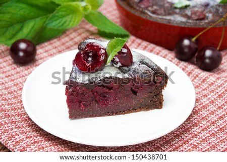 piece of chocolate Clafoutis with cherries and powdered sugar, close-up