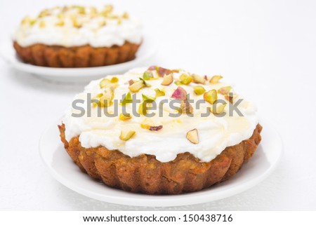 mini carrot cake with mascarpone, honey and pistachios, close-up