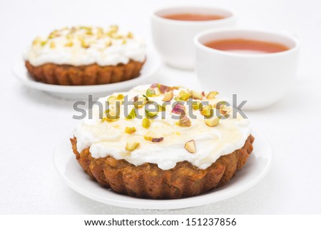 mini carrot cake with mascarpone, honey, pistachios and black tea, close-up
