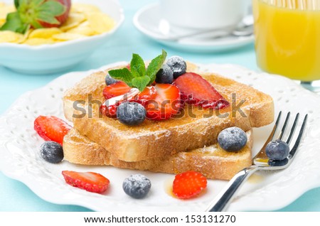 crispy toast with honey, fresh berries, cup of coffee, orange juice and cereal for breakfast, closeup, horizontal