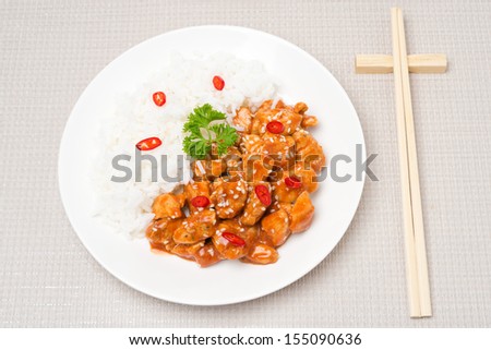chicken fillet in tomato sauce with sesame seeds and rice, top view, horizontal