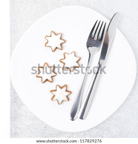Christmas table setting with cookies on a silver napkin, isolated on white