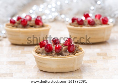 tartlets with liver pate and pomegranate seeds for Christmas, horizontal, close-up
