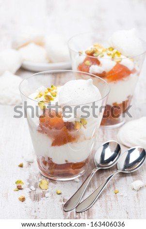 dessert with canned peaches, whipped cream and meringue, vertical, close-up