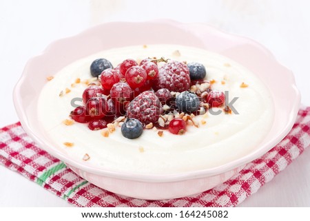 semolina porridge with berries and nuts, close-up, horizontal