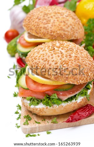 burger with smoked salmon and vegetables, isolated on white