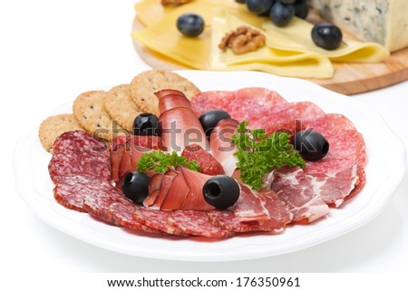 assorted deli meats and a plate of cheese, close-up, isolated