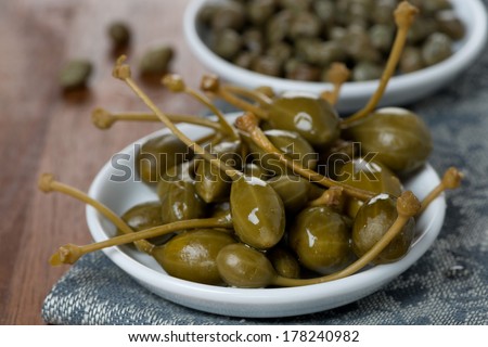 two kinds of pickled capers, close-up, horizontal