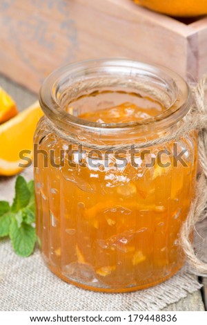 delicious orange marmalade in a glass jar, vertical