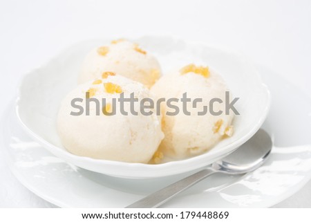 Close-up of ginger ice cream with melted milk in a bowl, horizontal