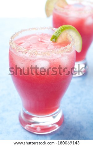 watermelon cocktail with brown sugar and lime in a glass, close-up, vertical