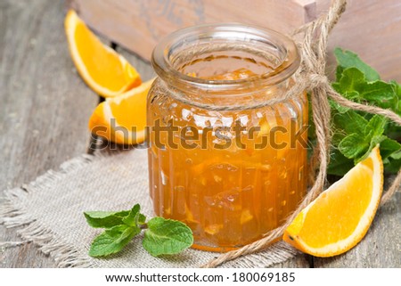 orange marmalade in a glass jar, close-up, horizontal