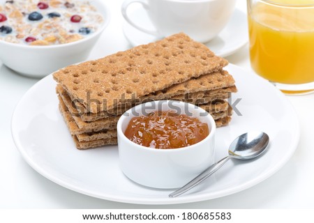 fresh breakfast - crisp bread with jam, orange juice and muesli with milk