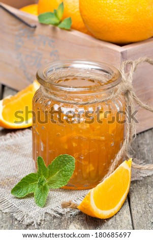 orange marmalade in a glass jar, vertical, close-up