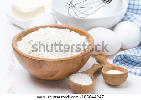 flour, salt, sugar and eggs for baking pancakes on wooden table, horizontal