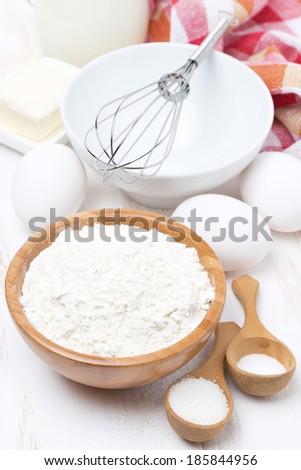 flour, salt, sugar and eggs for baking pancakes, vertical