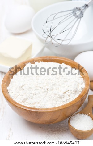flour, salt, sugar, butter and eggs for baking, vertical