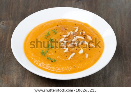 carrot soup with almonds and cress salad, close-up