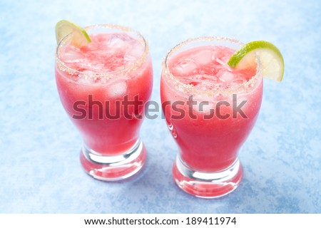 Two glasses of watermelon cocktail with brown sugar and lime, horizontal, close-up