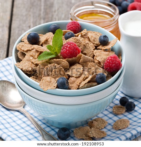 cereal with berries, honey, milk, close-up