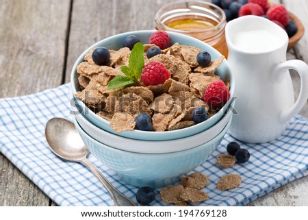 cereal with berries, honey and milk, closeup, horizontal