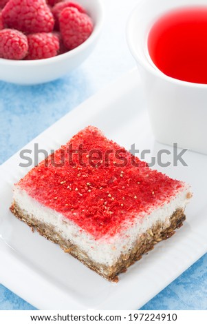 cream cakes with raspberry and fruit tea, top view, vertical