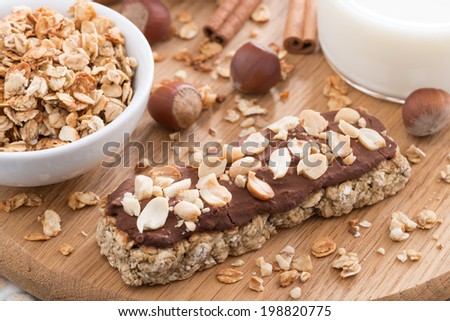 oat bar with chocolate on wooden board, horizontal