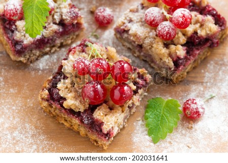 berry tart on a wooden board, top view, close-up, horizontal