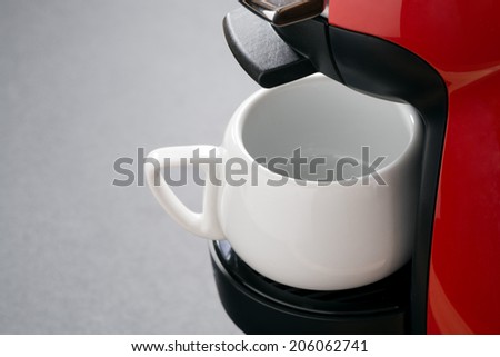 empty white coffee cup in the coffee machine, horizontal