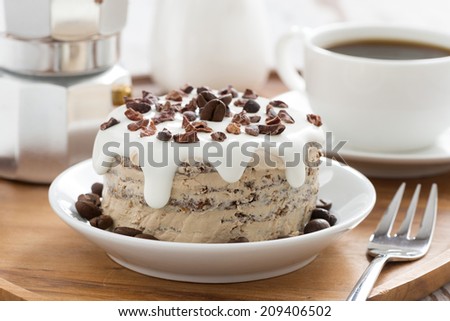 chocolate coffee cake with icing on a plate, horizontal, close-up
