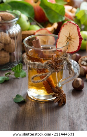 apple cider with spices in a glass cup, vertical, close-up
