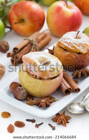 baked apples stuffed with dried fruit, nuts and cottage cheese on plate, vertical
