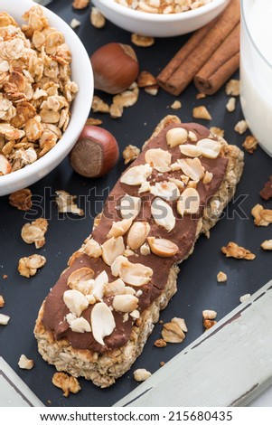 oat bar with chocolate and nuts, top view, vertical