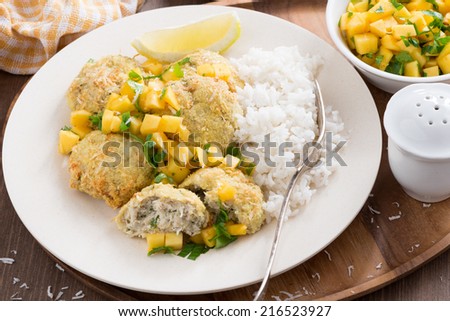Thai fish cakes with mango salsa and rice, top view