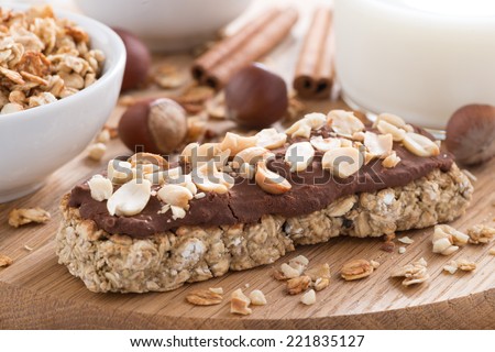 oat bar with chocolate on wooden board, selective focus, close-up
