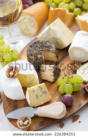 cheese platter, snacks, bread and wine, vertical, top view