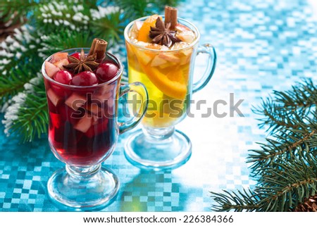festive Christmas mulled wine and apple cider on a blue background, close-up