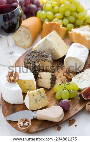 cheese platter, snacks, bread and wine, top view